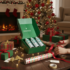 umanos green gift box with items on a wooden table in a festive living room.